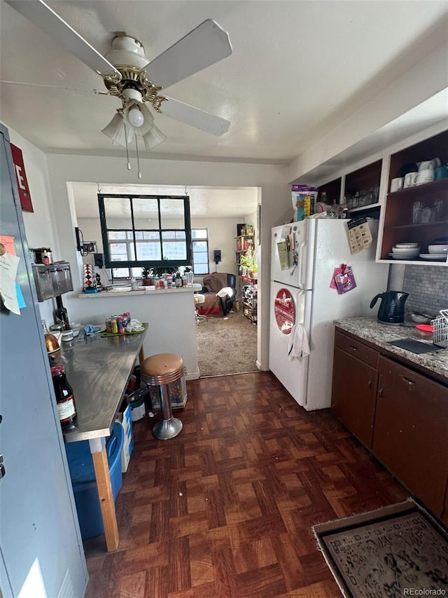 1265 Yates St, Denver, CO 80204 - kitchen featuring a ceiling fan, freestanding refrigerator, and dark brown cabinets