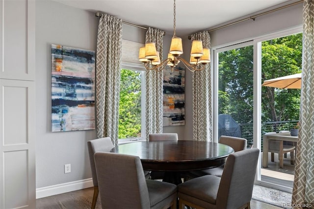 6175 Puma Sands, Lone Tree, CO 80124 - dining space featuring a chandelier, baseboards, and dark wood-style floors