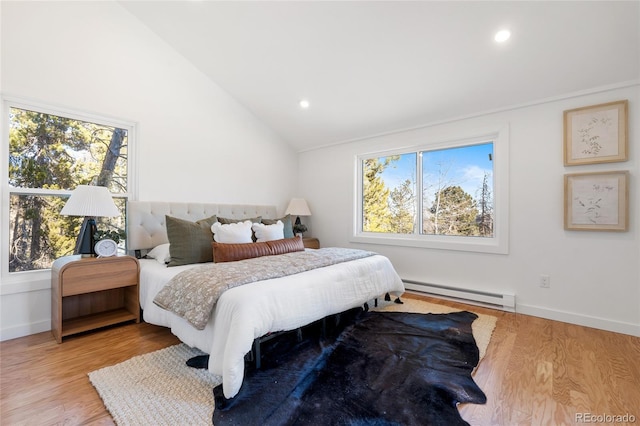 bedroom with light wood-type flooring, lofted ceiling, multiple windows, and a baseboard radiator