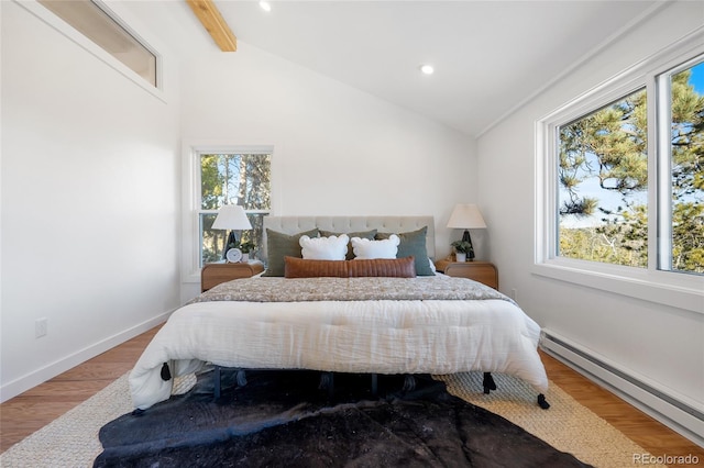 bedroom with hardwood / wood-style floors, a baseboard heating unit, and lofted ceiling with beams