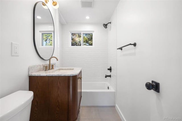 full bathroom with tile patterned floors, toilet, vanity, and tiled shower / bath