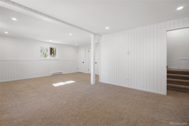 carpeted spare room featuring a baseboard radiator