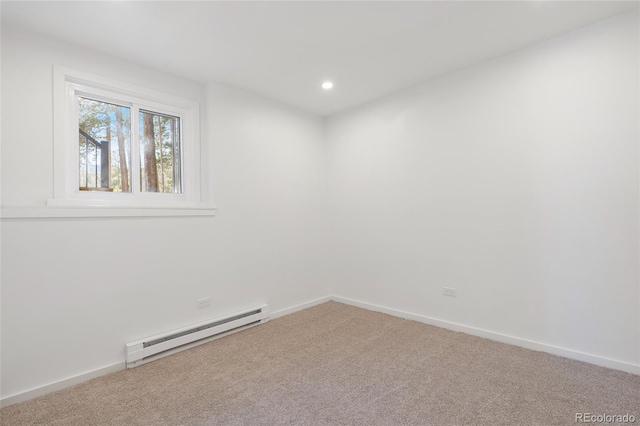 spare room with carpet flooring and a baseboard radiator