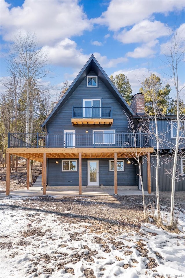 view of front of house with a patio area and a wooden deck