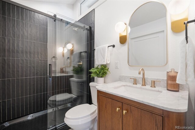 bathroom featuring vanity, toilet, and walk in shower