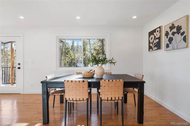 dining space with plenty of natural light and wood-type flooring