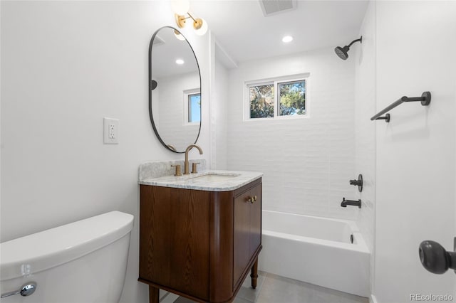 full bathroom with vanity, tile patterned flooring, tiled shower / bath combo, and toilet