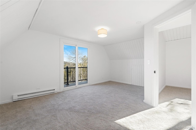 additional living space featuring light colored carpet, a baseboard radiator, and vaulted ceiling