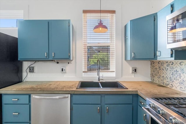 kitchen featuring stainless steel appliances, a sink, and blue cabinetry