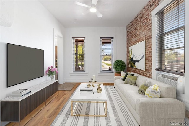 1103 Lipan St, Denver, CO 80204 - living room with light wood-type flooring, ceiling fan, brick wall, and baseboards