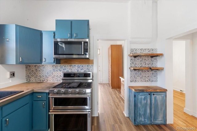1103 Lipan St, Denver, CO 80204 - kitchen with stainless steel appliances, blue cabinets, and light wood-type flooring