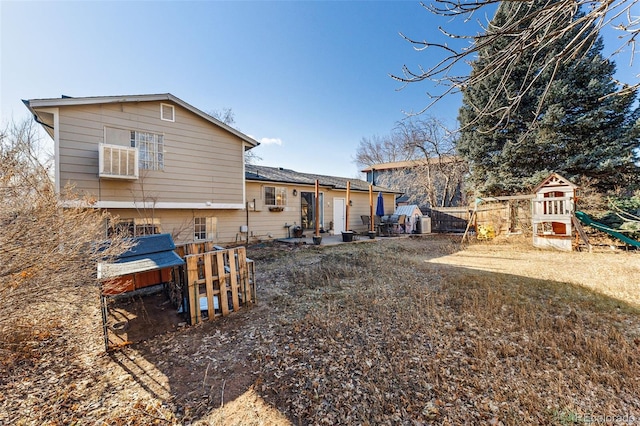 back of property featuring a patio, a playground, and a lawn