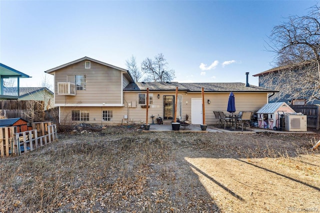 rear view of house with a patio, a balcony, and a storage unit