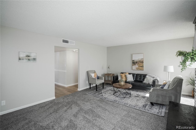 3855 S Monaco St Unit 208, Denver, CO 80237 - living area with carpet floors and a textured ceiling