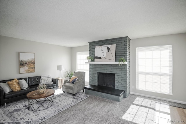 3855 S Monaco St Unit 208, Denver, CO 80237 - living area with a fireplace, a textured ceiling, and carpet floors