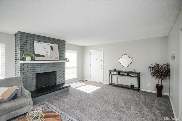 3855 S Monaco St Unit 208, Denver, CO 80237 - carpeted living room with a textured ceiling and a brick fireplace