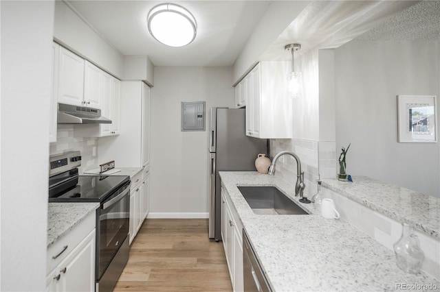 3855 S Monaco St Unit 208, Denver, CO 80237 - kitchen with stainless steel appliances, under cabinet range hood, decorative backsplash, and light stone countertops
