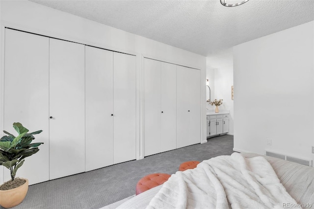 4248 Corriente Pl, Boulder, CO 80301 - carpeted bedroom featuring two closets, a textured ceiling, and connected bathroom