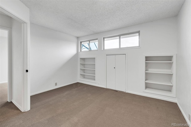 4248 Corriente Pl, Boulder, CO 80301 - entryway with dark colored carpet, a textured ceiling, and baseboards