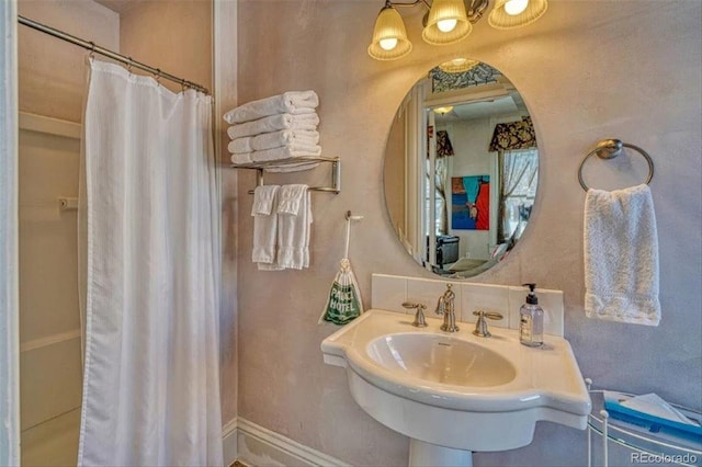 bathroom featuring sink and a shower with shower curtain