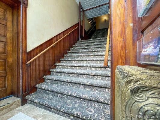 staircase with wooden walls