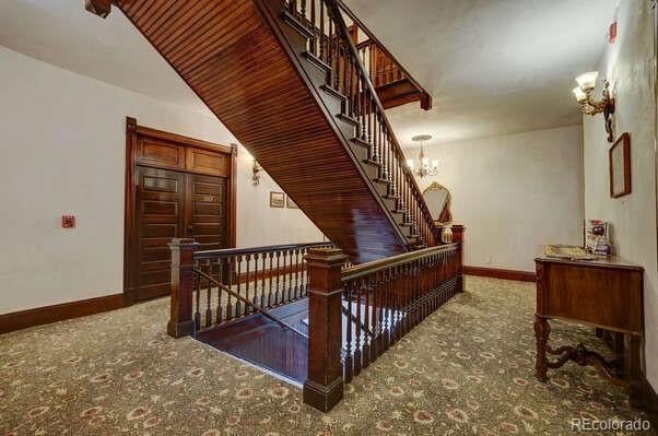 stairway with an inviting chandelier