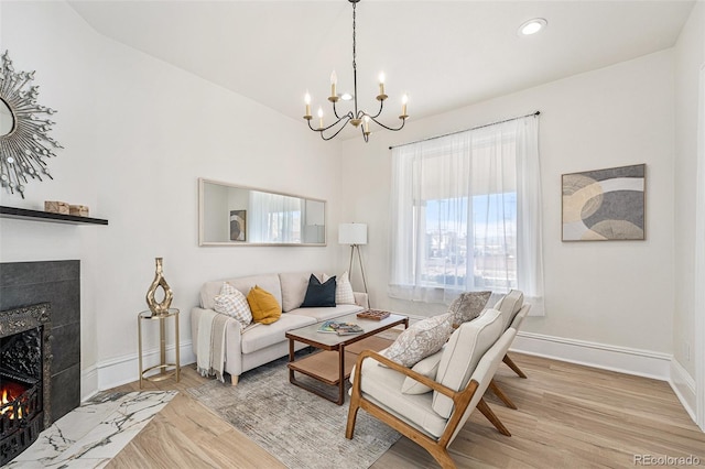 living room featuring light wood-type flooring and an inviting chandelier