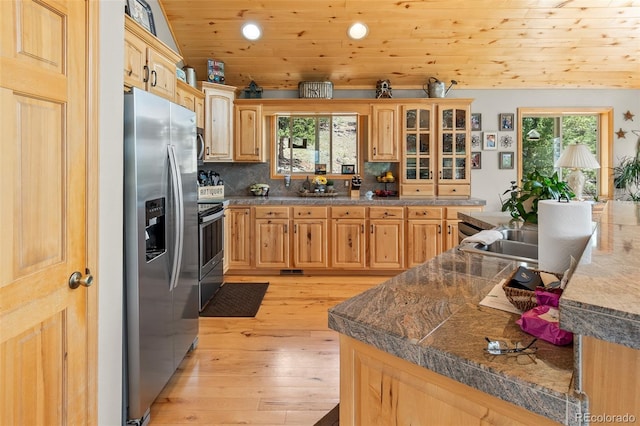 kitchen featuring light brown cabinetry, wood ceiling, vaulted ceiling, appliances with stainless steel finishes, and light hardwood / wood-style floors