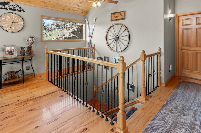 staircase with lofted ceiling, wood ceiling, hardwood / wood-style flooring, and ceiling fan