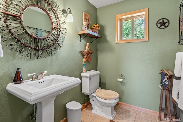 bathroom with tile patterned flooring, sink, and toilet