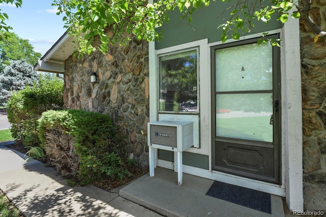 doorway to property with stone siding