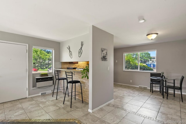 kitchen featuring visible vents, plenty of natural light, and backsplash