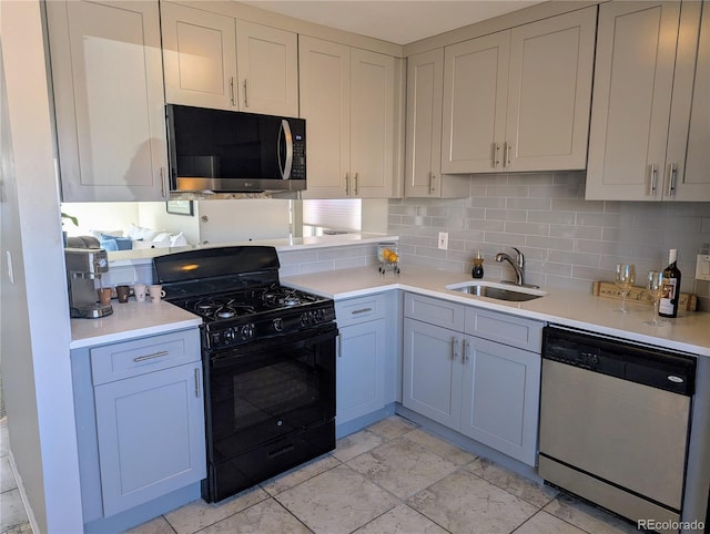 kitchen with decorative backsplash, light countertops, stainless steel dishwasher, a sink, and gas stove