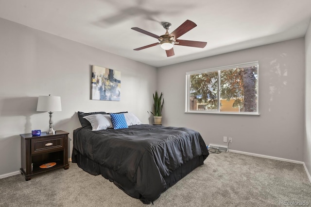 bedroom with a ceiling fan, baseboards, and carpet flooring