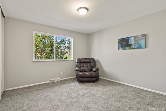 unfurnished room featuring baseboards, visible vents, and carpet flooring