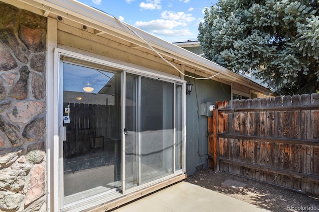 view of exterior entry with fence