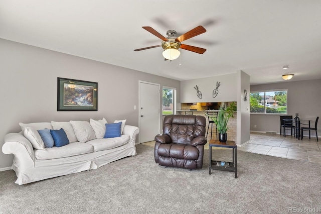 2246 N Coronado Pkwy Unit A, Denver, CO 80229 - carpeted living area featuring plenty of natural light, a ceiling fan, baseboards, and tile patterned floors