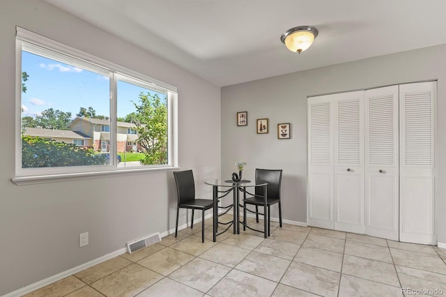 2246 N Coronado Pkwy Unit A, Denver, CO 80229 - dining area featuring light tile patterned floors and baseboards
