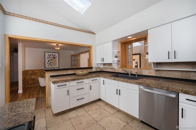 kitchen featuring a sink, dark countertops, white cabinets, and stainless steel dishwasher