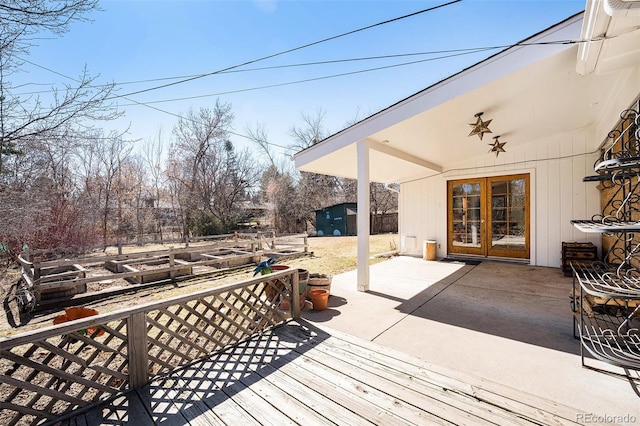 wooden deck with a patio area and an outbuilding