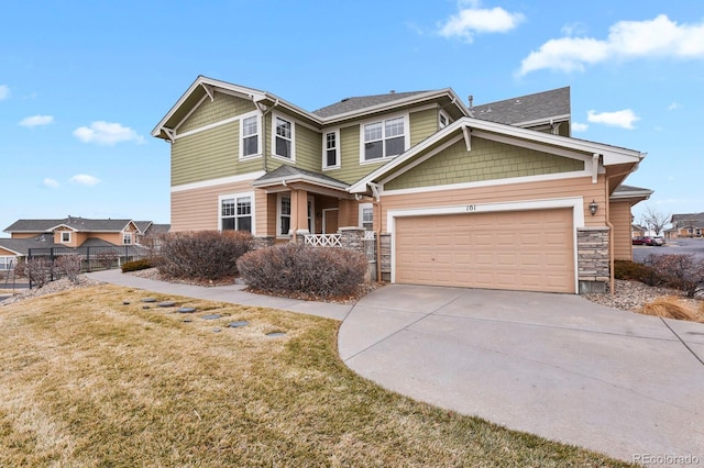 craftsman-style home with a garage, fence, concrete driveway, stone siding, and a front lawn