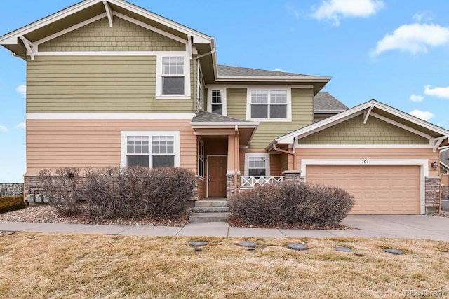 craftsman-style house with roof with shingles, driveway, and an attached garage