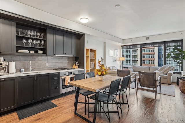 1750 Wewatta St Unit 525, Denver, CO 80202 - dining space with light wood-type flooring and bar