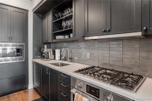 1750 Wewatta St Unit 525, Denver, CO 80202 - kitchen featuring stainless steel appliances, light countertops, open shelves, and decorative backsplash
