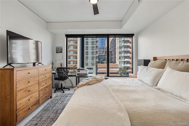 1750 Wewatta St Unit 525, Denver, CO 80202 - carpeted bedroom featuring a wall of windows, an office area, a ceiling fan, and a city view