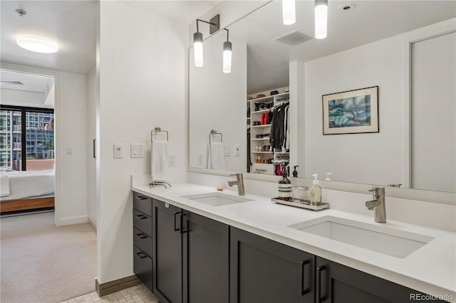 1750 Wewatta St Unit 525, Denver, CO 80202 - bathroom featuring double vanity, a spacious closet, and ensuite bathroom