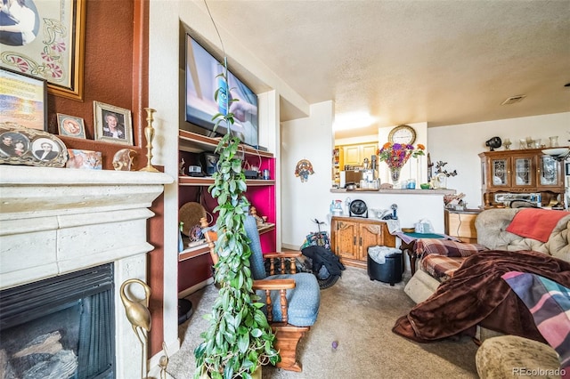 living area with a textured ceiling, a fireplace, and carpet flooring