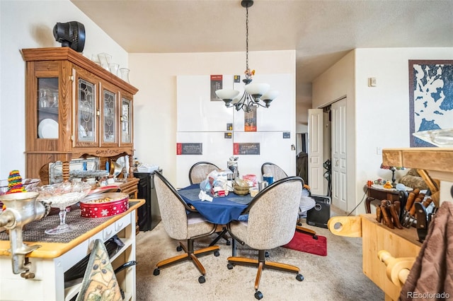 dining space with carpet floors and a chandelier