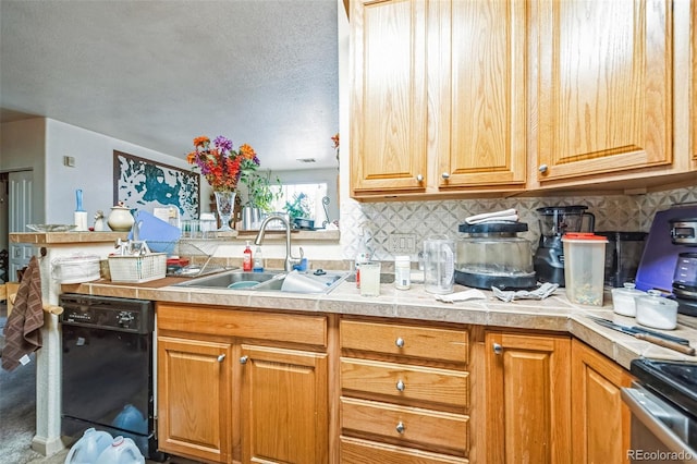 kitchen featuring stainless steel stove, a sink, black dishwasher, light countertops, and tasteful backsplash