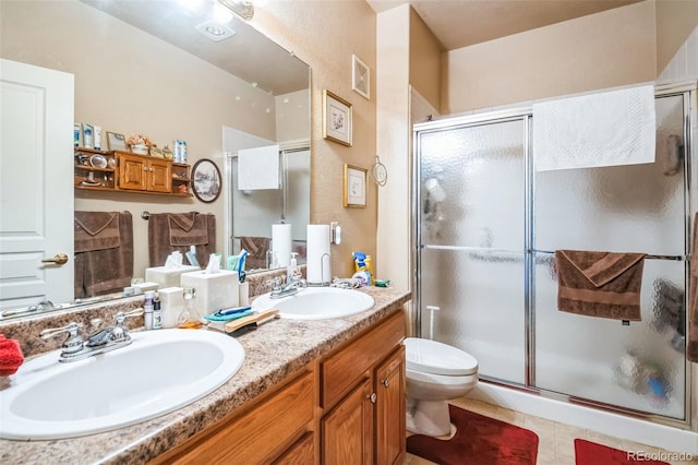 bathroom featuring visible vents, a sink, a shower stall, and toilet